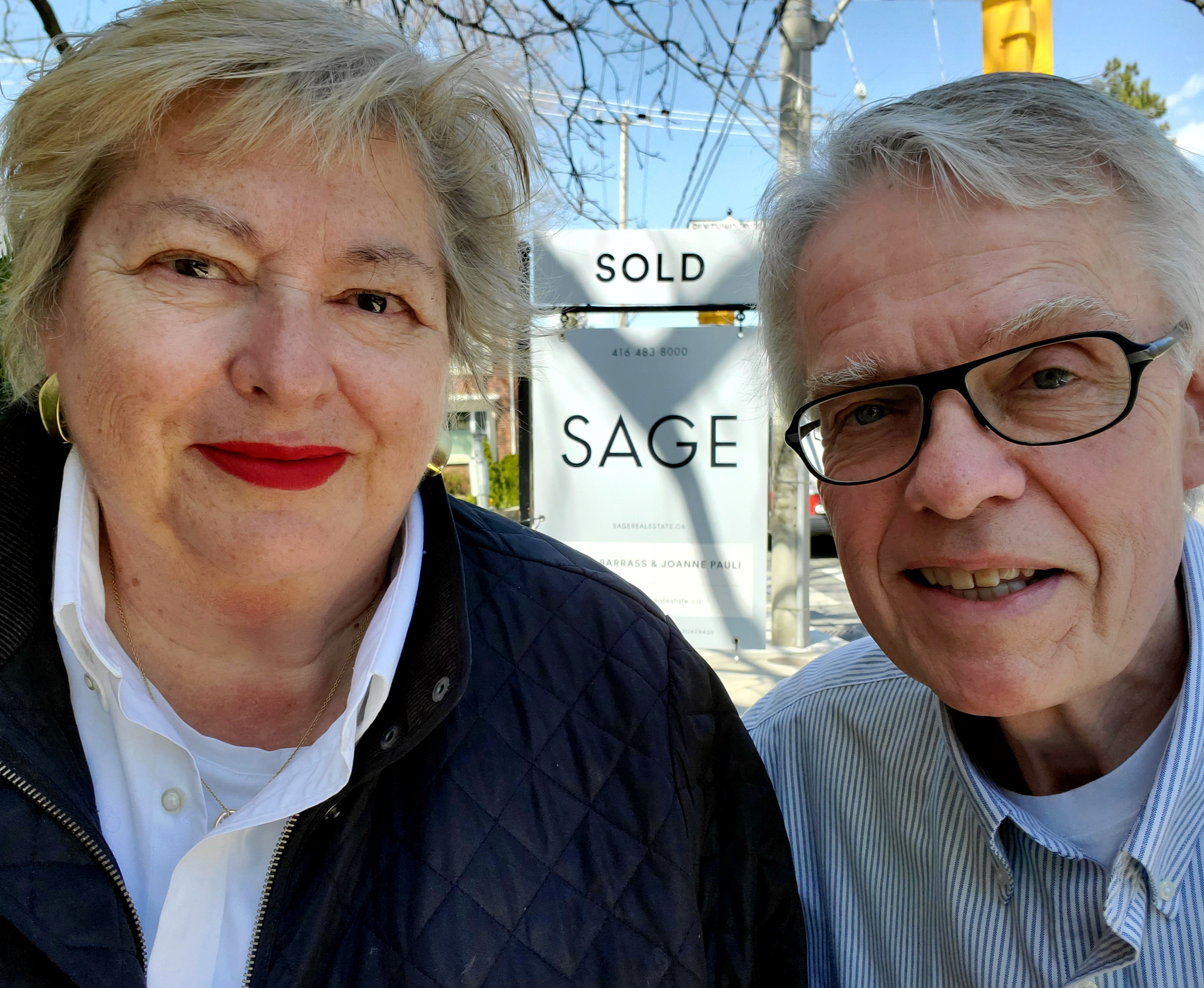 Joanne and James in front of Sage "sold" sign.